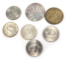 A quantity of coins, to include two silver coloured Arabic examples. (7)