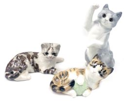 Three Winstanley and Hinton ceramic cats, comprising grey leaping cat, 29cm high, seated mottled cat