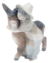 A Lladro figure group of a child and donkey, stamped to underside, 20cm high.