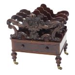 A Victorian rosewood Canterbury, with three pierced and scroll shaped divisions above a drawer, on t