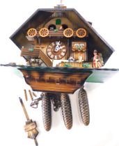 A large Black Forest cuckoo clock, modelled in the form of a Swiss chalet, with moving figures, etc.