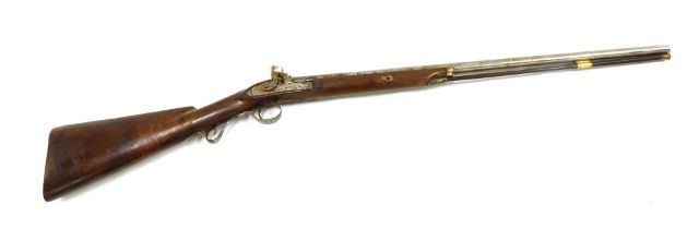 A 19thC percussion musket, with engraved barrel, side lock plate and hammer, bears indistinct inscri