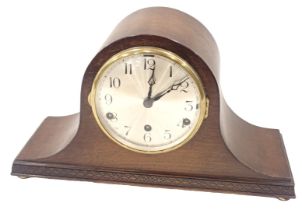 An oak cased Napoleon's hat mantel clock, with a silvered numeric dial and brass chapter ring, in a
