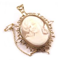 A 9ct gold shell cameo pendant/brooch, the raised relief cameo depicting figure with flowing hair in