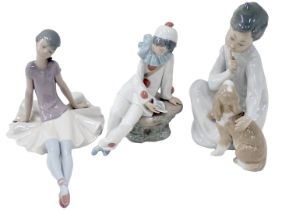 Three Lladro figures, comprising a seated child with dog, seated ballerina, and a clown, the largest