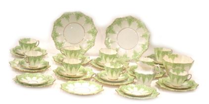 A Paragon china tea service, with a fluted and gilded border, with lattice and green moulded decorat