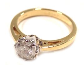 An 18ct gold diamond solitaire dress ring, the round brilliant cut diamond in a raised claw basket s