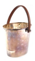 A silver plated bucket shaped wine cooler, with brown leather handle, 37cm high.