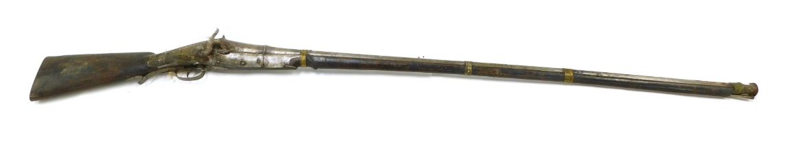 A 19thC Continental percussion musket, with flared muzzle, ramrod, and brass bindings to barrel, wit