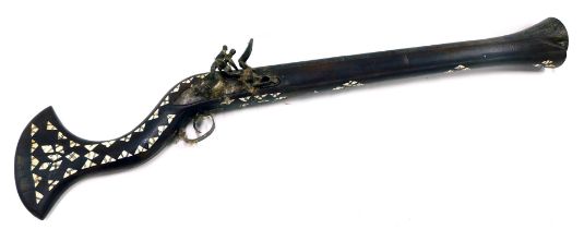 A 19thC Middle Eastern flintlock blunderbuss, the barrel engraved with flower heads and heart shaped