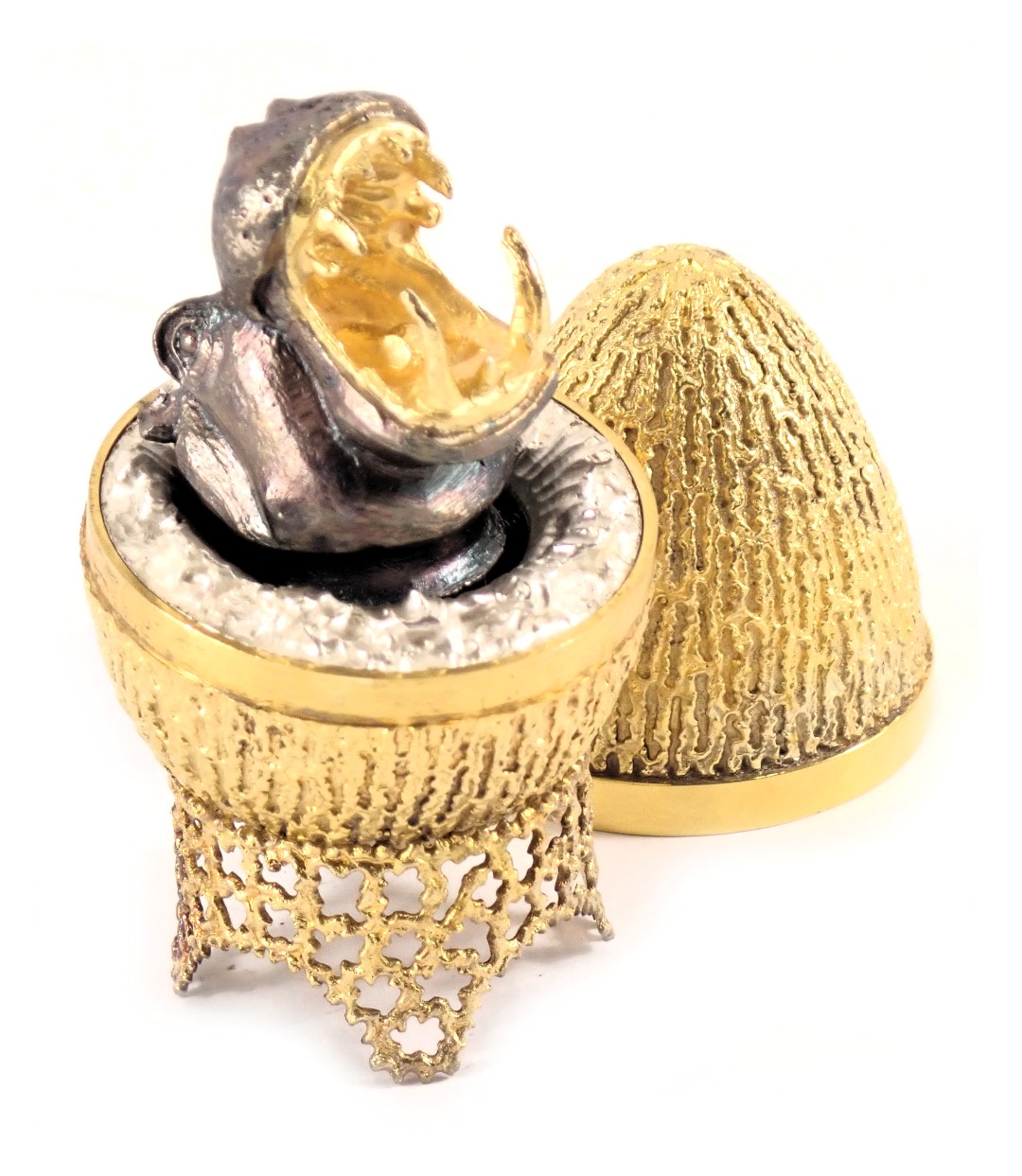 A Stuart Devlin silver parcel gilt Hippo egg, London 1973, with unmarked silver gilt coloured stand,