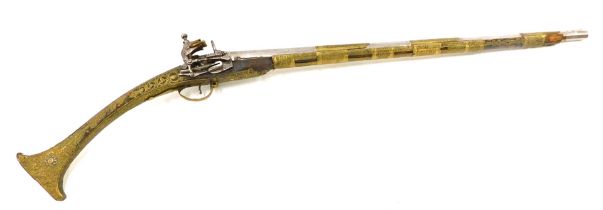 An early 19thC Ottoman miquelet-lock musket, with engraved brass bindings and overlay to the barrel