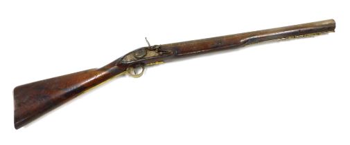 A late 18thC flintlock blunderbuss with slightly flared muzzle, lacking flintlock action, with ramro