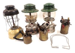Two Colman's paraffin lamps, a camping lamp, and three part brass blow torches. (6)