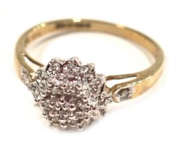 A 9ct gold diamond cluster ring, the raised flora cluster set with tiny diamonds, totalling 0.05ct,