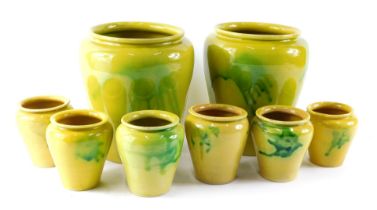 A collection of Continental green and yellow glazed rustic vases or jars, 19cm high, etc.