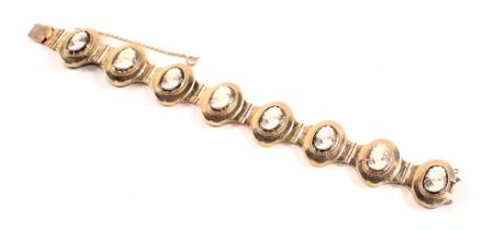 A cameo bracelet, with eight oval panels, each with raised cameo depicting female figure, in a rubbe