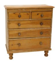 A Victorian pine chest of drawers, the top with a moulded edge above two short and three long drawer