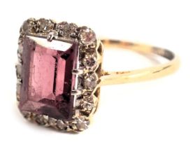 A garnet and diamond dress ring, with rectangular claw set vodalite/rhodolite garnet, 9mm x 7mm, rai