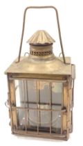 A 19thC brass paraffin lantern, the domed top with a pierced border above a glazed door, on bun feet