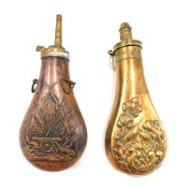 A 19thC brass powder flask, embossed with birds, trees, etc. stamped patent, 20cm long, and another