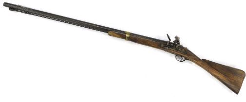 A 19thC left handed flintlock musket by Smith and Co, with brass banded barrel and elm stock, the si