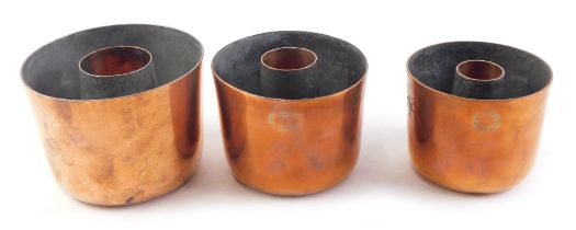 An associated graduated set of three copper jelly moulds, two stamped Jones Brothers, 4 Down Street