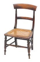 A Victorian mahogany child's chair, with a bar back and caned seat.