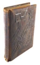 A 19thC leather photograph album, with embossed floral front plate, and various photographs. (AF)