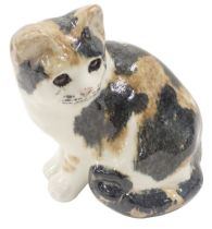 A Winstanley seated cat, on a brown and black mottled body with amber eyes, 21cm high, signed.