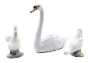 A Lladro seated swan and two Nao ducks.