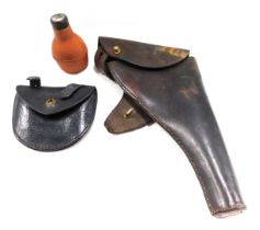 A brown leather gun holster, a leather ammunition pouch, etc.