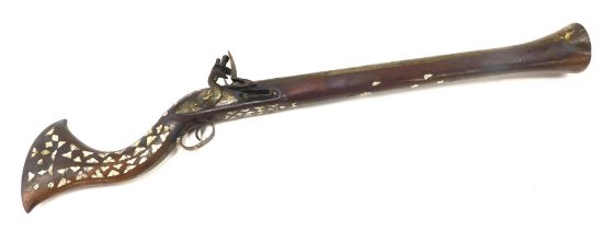 A 19thC Middle Eastern flintlock blunderbuss, the barrel engraved with flower heads and heart shaped