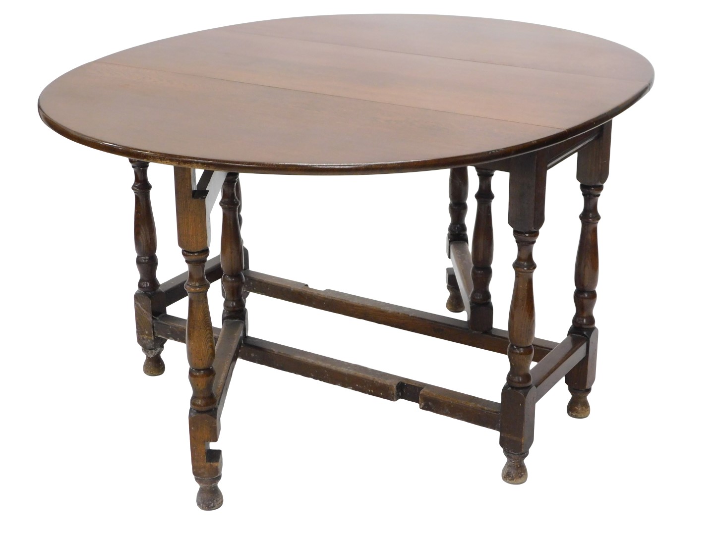 An oak oval drop leaf table, on turned supports, 113cm wide.