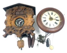 A late 20thC walnut cuckoo clock, and a Continental postman's alarm wall clock. (2)