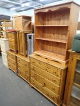 A pine low bookcase, chest of four drawers, two three drawer chests, bedside table, kitchen cabinet,