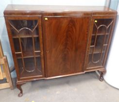 A mahogany bookcase with two astragal glazed doors and central cupboard.