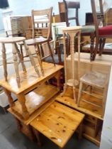 A pine TV stand, two pine coffee tables, a square pine side table, stool, two chairs and a carved pl