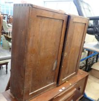 A stained pine two door cupboard.