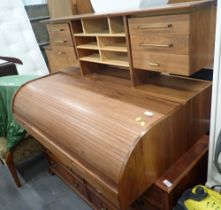 An ergonomic hardwood desk top, the roll top with a letter rack and drawer back, lacking base.