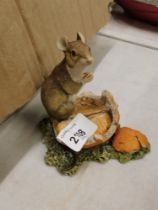 A Border Fine Arts mouse ornament, perched on a half eaten orange, stamped to underside.