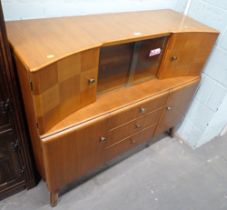 A teak sideboard, with two cupboard section and slide door above arrangement of three drawers and tw