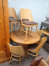 A set of six oak and brown leatherette seated chairs.