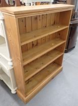 A pine bookcase, with four shelves.