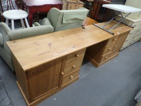 A substantial pine office desk, with two twin pedestals, to include two drawer sections and two cupb