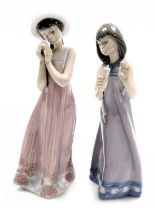 Two Lladro porcelain figures, one of a standing girl holding a candle, no 5606, the other of a girl