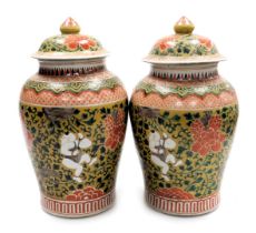 A pair of Chinese porcelain baluster jar and covers, decorated with boys clambering among scrolling