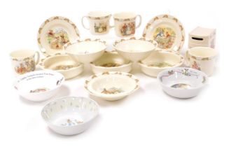 A group of Royal Doulton Bunnykins table wares, including baby's and cereal bowls, mugs, and a book