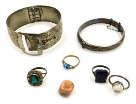 A group of costume jewellery, comprising a silver hinged bangle, three dress rings, each of Deco des