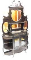 A Victorian ebonised mirror back display cabinet, with a pierced and foliate carved swan neck pedime